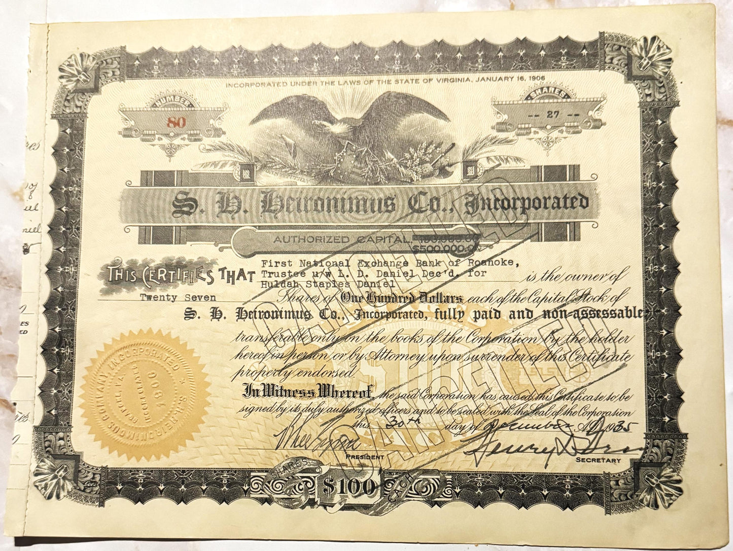 Sepia-toned S.H. Heironimus Co. stock certificate with eagle emblem, gold seal, ornate border, and handwritten signature