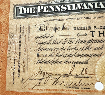 Vintage Pennsylvania Railroad stock certificate with ornate border, handwritten signatures, and "Pennsy" header on aged cream