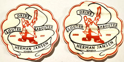 Two cream-colored scalloped coasters with red borders featuring a red leprechaun figure, "Drink Louter Kabouter" text, "Herma