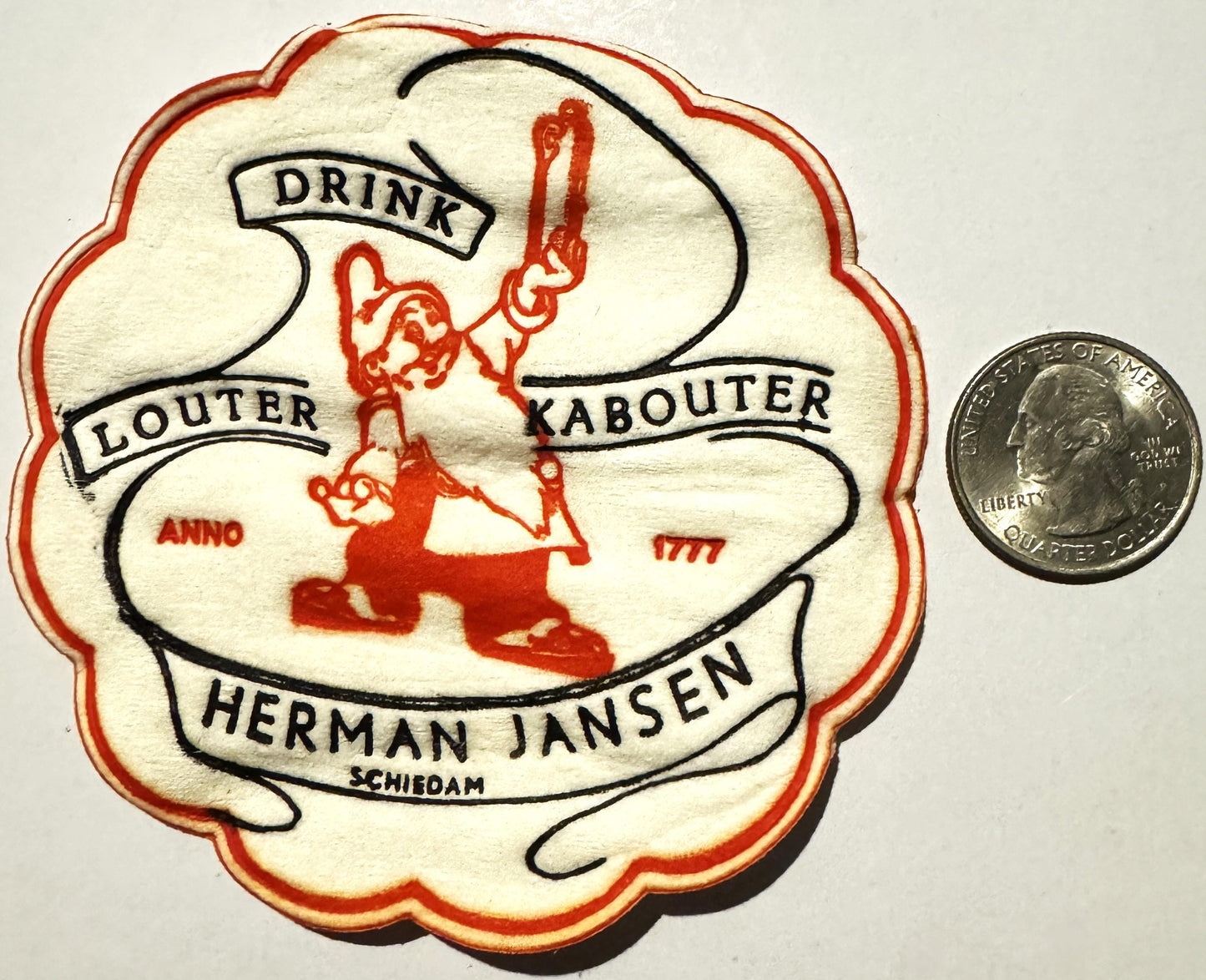 Vintage cloth coaster with red and black design featuring a leprechaun character, "Drink Louter Kabouter" text, and "Herman J