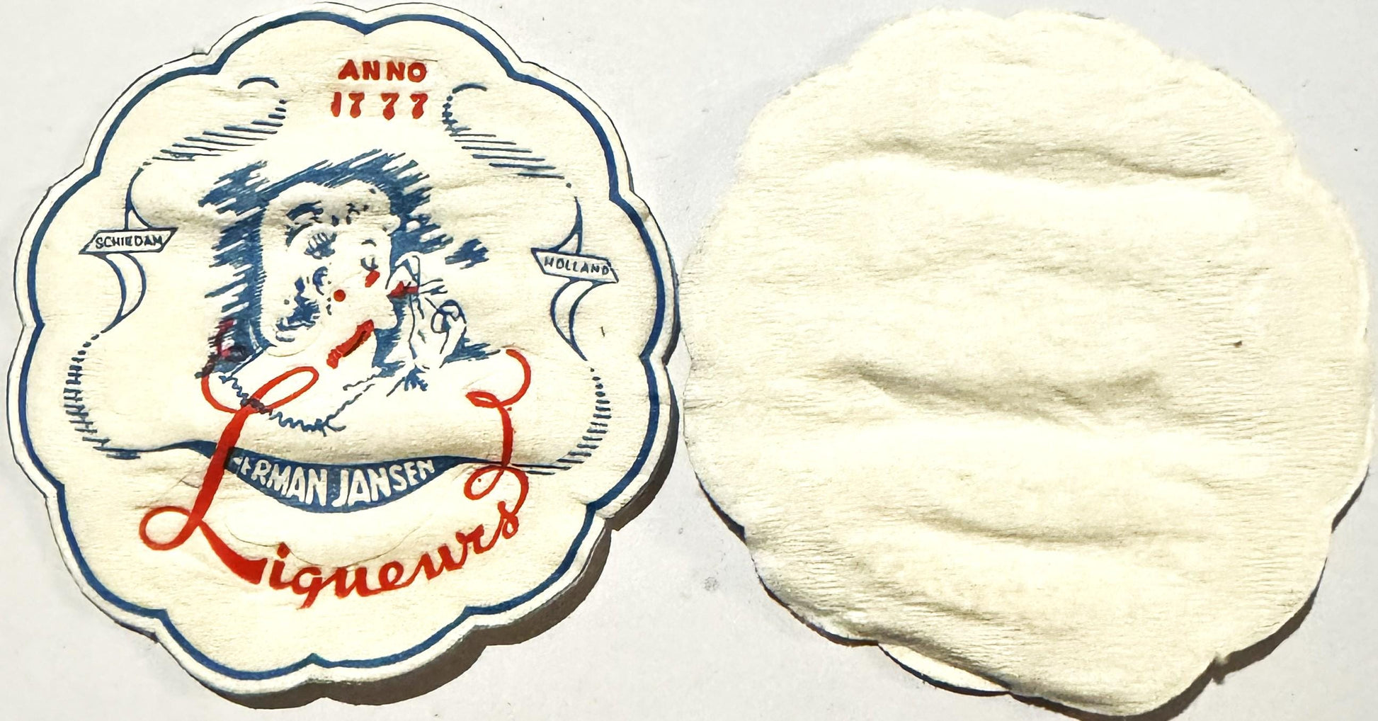 Ornate cloth coaster with scalloped edges showing a woman's face in profile, labeled "Herman Jansen Liqueurs" and "Anno 1777,