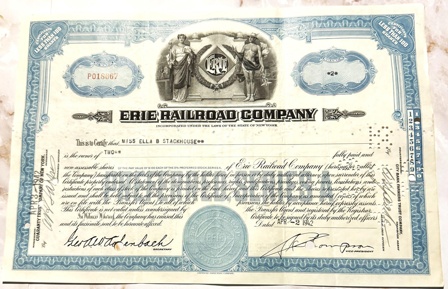 Blue and cream Erie Railroad Company stock certificate from, featuring allegorical figures, ornate border design, and co