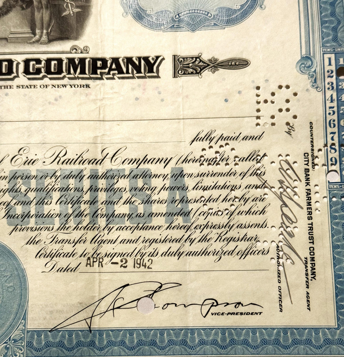 Vintage Erie Railroad stock certificate, with blue ornamental borders, printed text, and handwritten sign