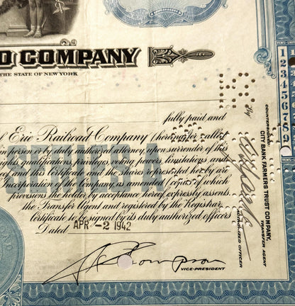 Vintage Erie Railroad stock certificate, with blue ornamental borders, printed text, and handwritten sign