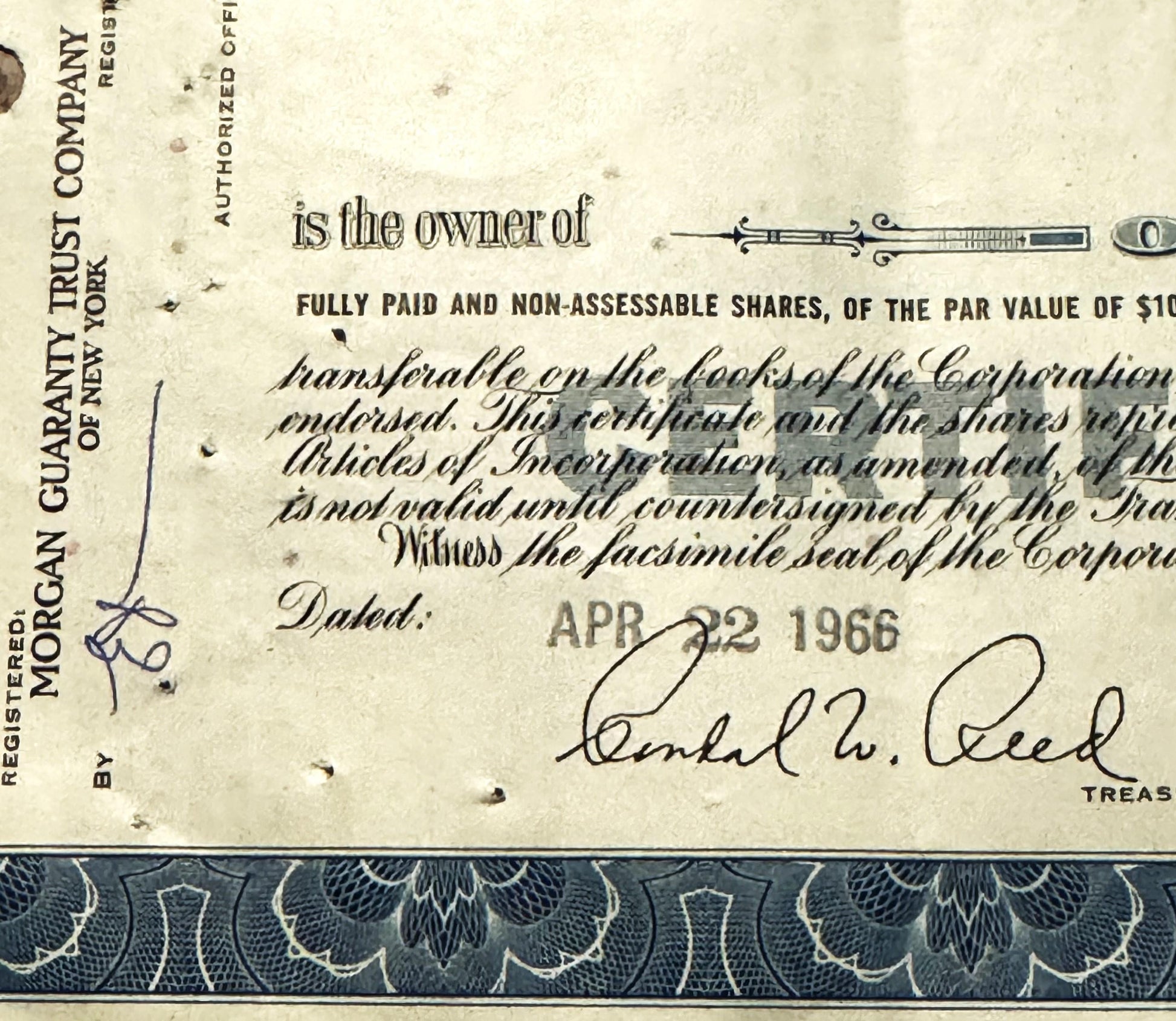 Closeup of Atlantic Refining Company stock certificate with ornate border, showing signature line dated APR 22 and