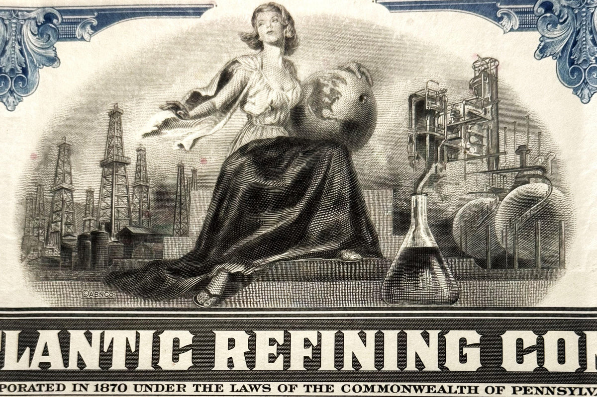 Ornate stock certificate header with industrial imagery: woman figure, oil derricks, refinery buildings, flask, and decorativ