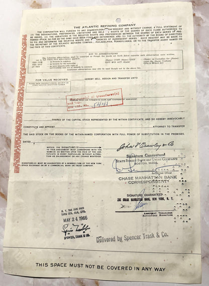 Aged stock certificate from The Atlantic Refining Company with red margin markings, signatures, and bank stamps dated May 24,