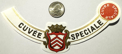 Antique French wine label with ornate crowned heraldic crest, "Cuvée Spéciale" text, and red wax seal, shown with quarter coi