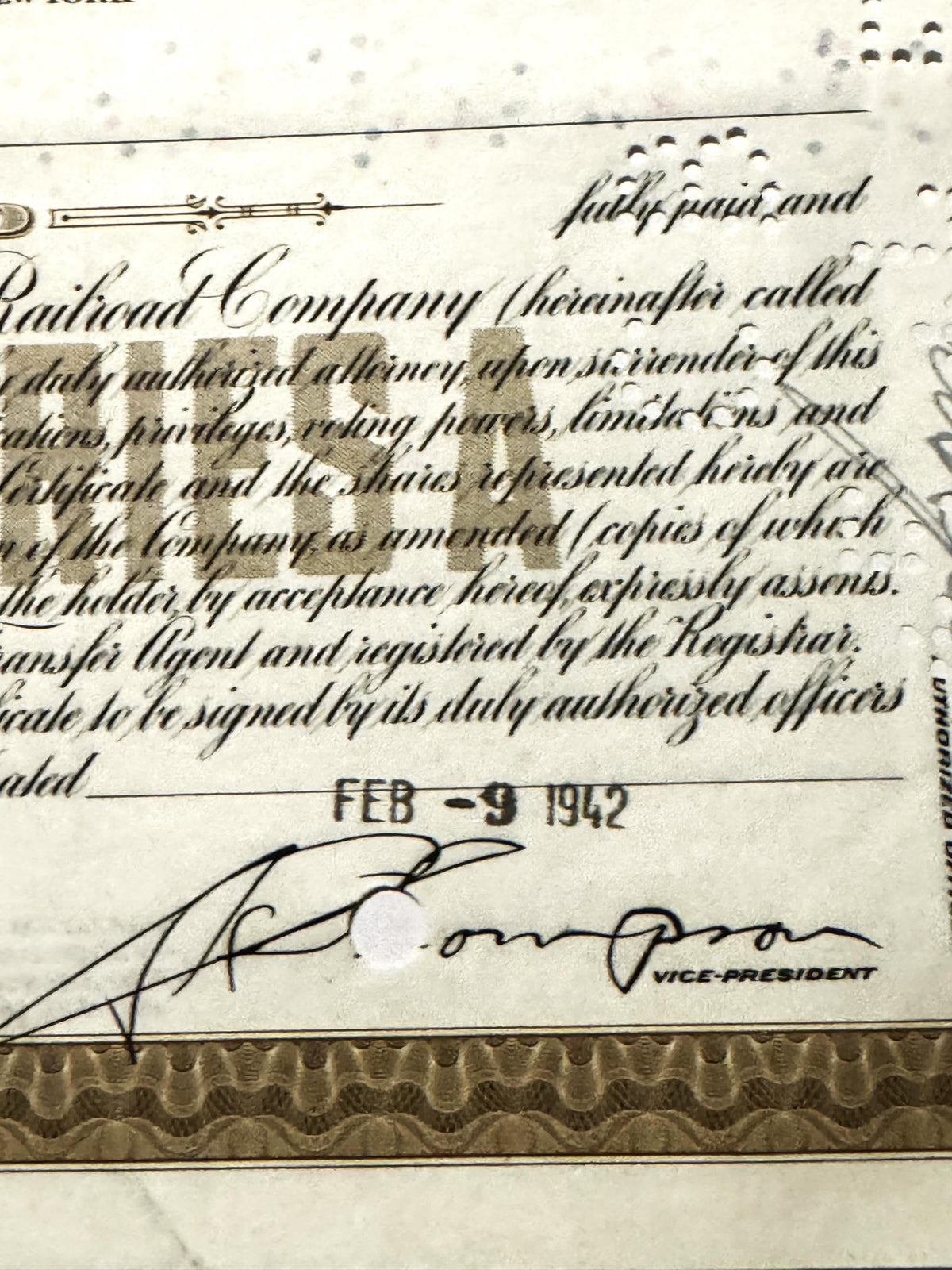 Close-up of vintage Erie Railroad stock certificate showing handwritten cursive text, official seal, signature dated FEB 9 19