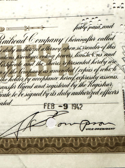 Close-up of vintage Erie Railroad stock certificate showing handwritten cursive text, official seal, signature dated FEB 9 19