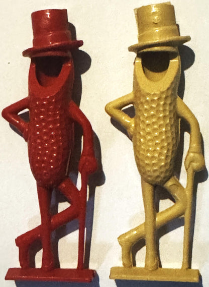 Two vintage Mr. Peanut plastic figurines in red and gold with top hats, standing pose, textured bodies with arms on hips