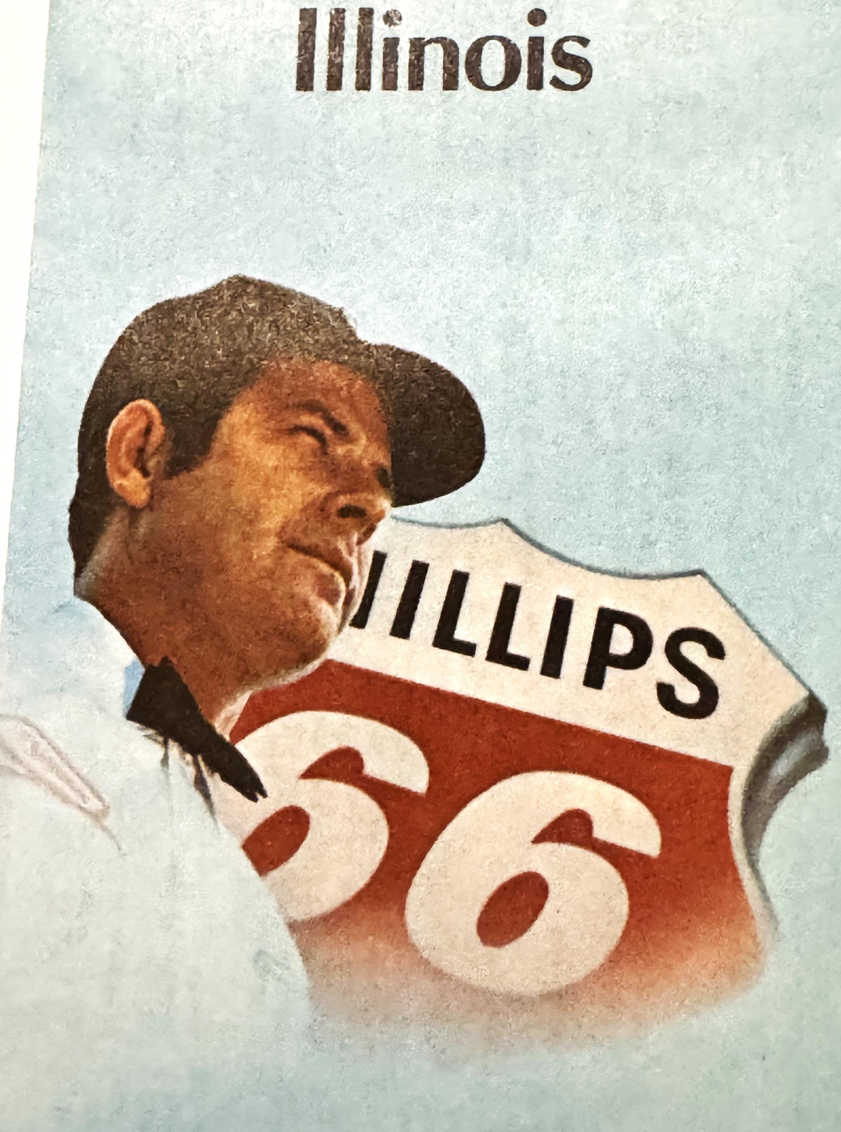 Vintage Illinois Phillips 66 map featuring a man in a cowboy hat wearing a red and white jersey numbered 56, against a light 