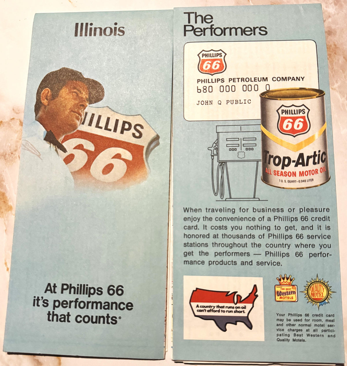 Vintage Phillips 66 Route 66 Illinois folded map with gas pump, oil can, and credit card imagery displayed open on textured s