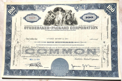 Studebaker-Packard Corporation stock certificate for 100 shares, featuring blue ornamental borders an