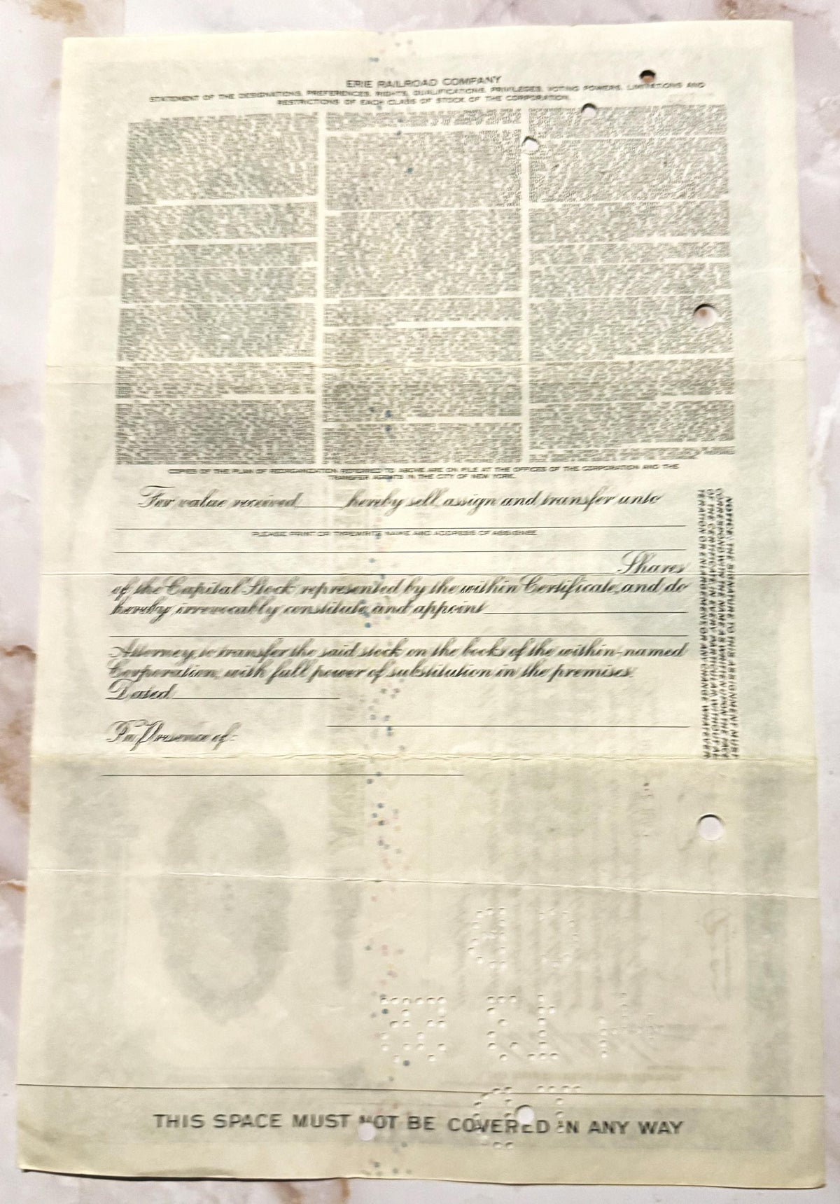 Cream-colored Erie Railroad stock certificate from mid-20th century with printed text and decorative vignette, showing age sp