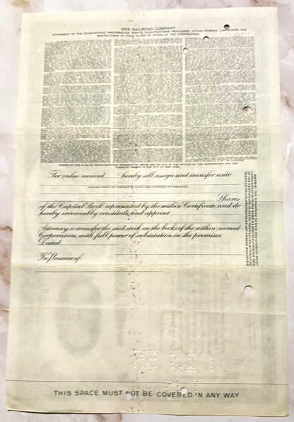 Cream-colored Erie Railroad stock certificate from mid-20th century with printed text and decorative vignette, showing age sp