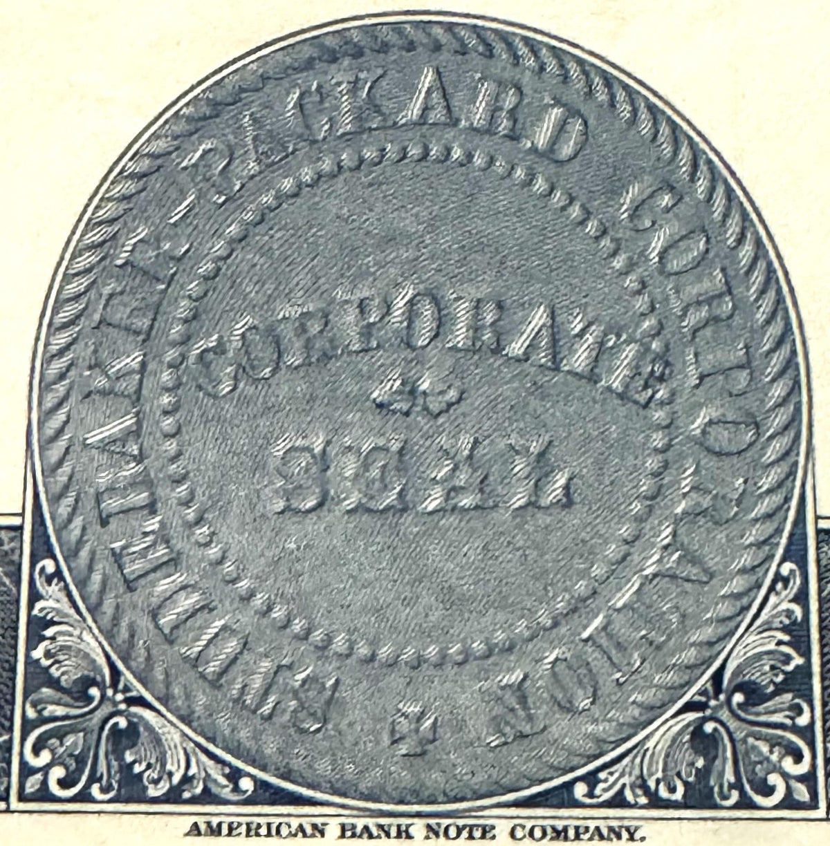 Close-up of ornate stock certificate reverse side with "AMERICAN BANK NOTE COMPANY" printed at bottom, decorative corner flou