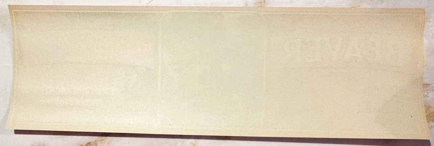 Blank cream-colored vintage crate label with dark brown stripe along bottom edge, shown flat against white background