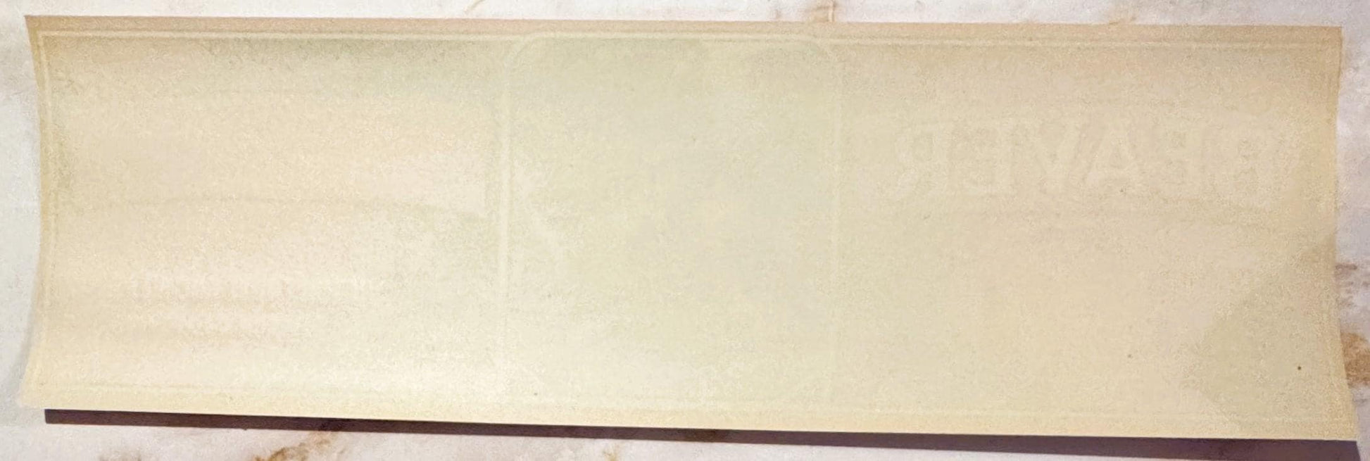 Blank cream-colored vintage crate label with dark brown stripe along bottom edge, shown flat against white background