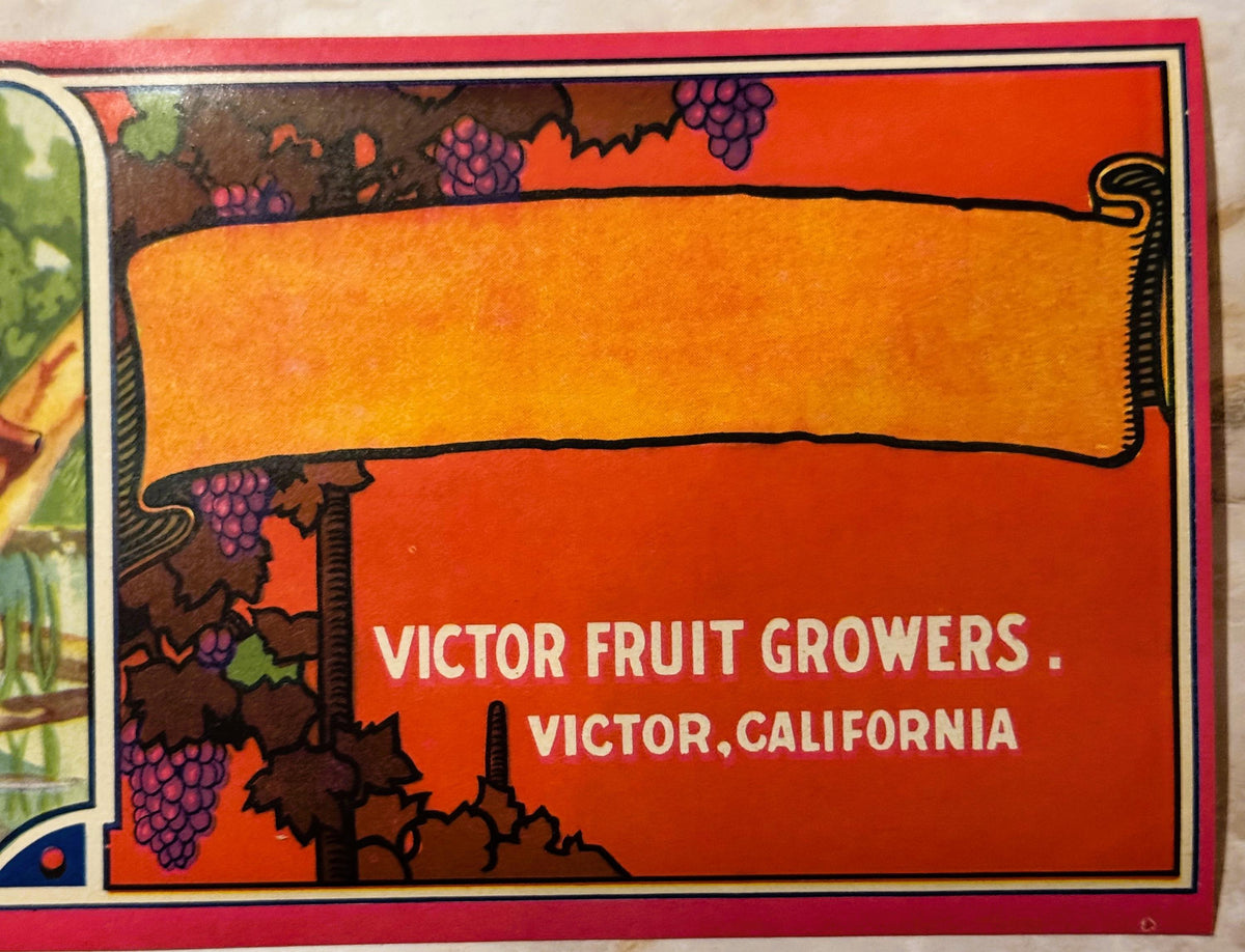 Vintage fruit crate label with orange banner, purple grapes, and text "Victor Fruit Growers, Victor, California" on red backg