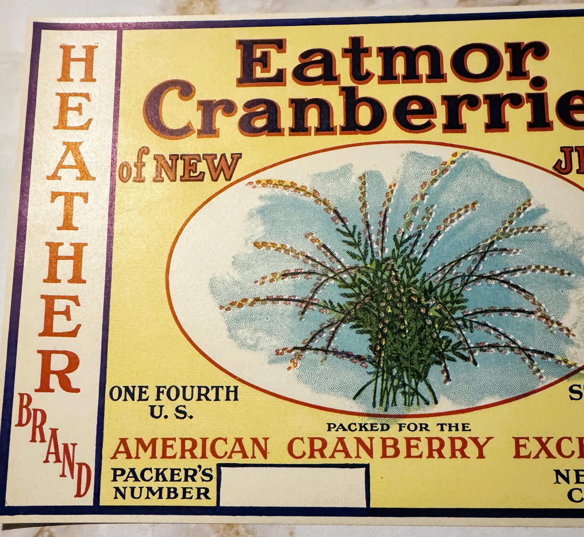 Vintage cranberry barrel label with yellow background, orange and black text reading "Heather Brand Eatmor Cranberries of New