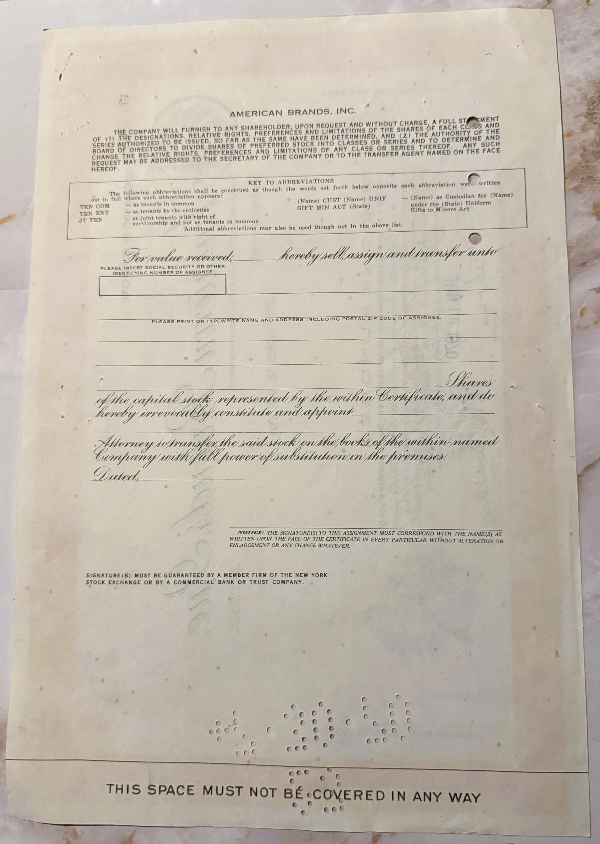 Vintage American Brands Inc stock certificate with ornate script and decorative vignette, printed on cream paper with visible