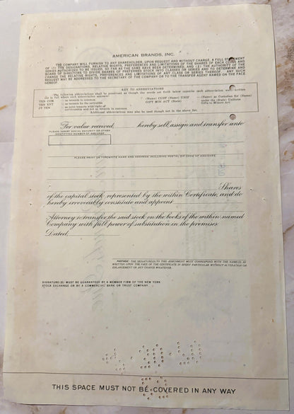 Vintage American Brands Inc stock certificate with ornate script and decorative vignette, printed on cream paper with visible