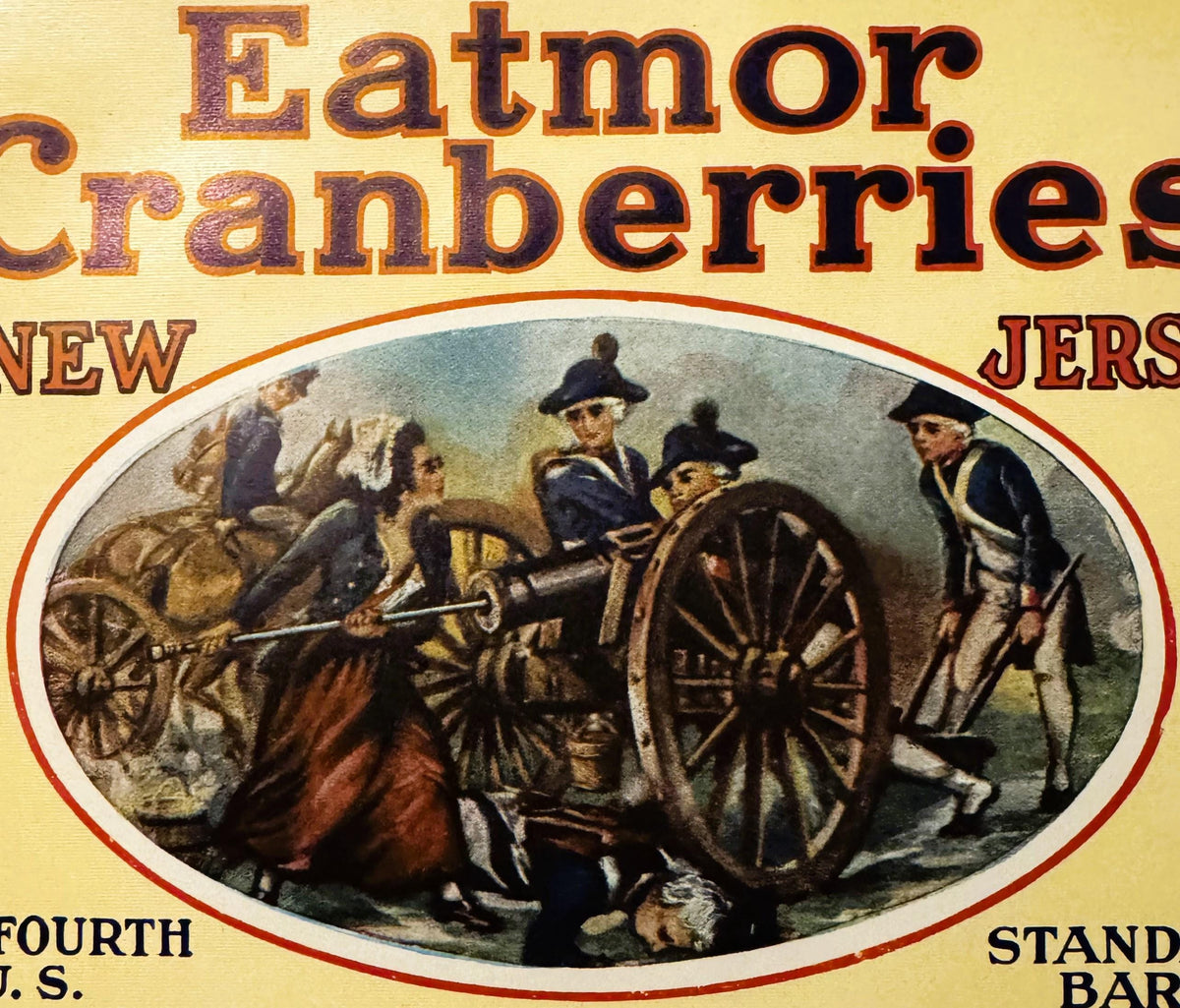 Vintage Eatmor Cranberries barrel label with red and gold text, featuring colonial soldiers with a cannon in an oval illustra