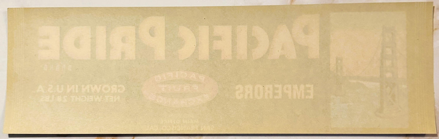 Faded vintage crate label with embossed "Emperor" text at top and oval logo, cream-colored paper with minimal visible printin