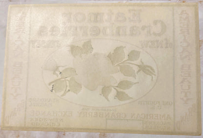 Faded cream-colored vintage cranberry barrel label with oval botanical illustration of leaves and berries, embossed text part