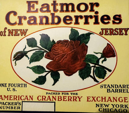 Vintage cranberry barrel label featuring a deep red rose with green leaves on cream background, text reading "Eatmor Cranberr