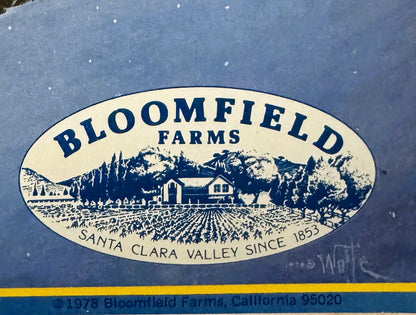 Vintage 1978 Bloomfield Farms firewood crate label with cream oval featuring ranch scene, mountains, and text "Santa Clara Va