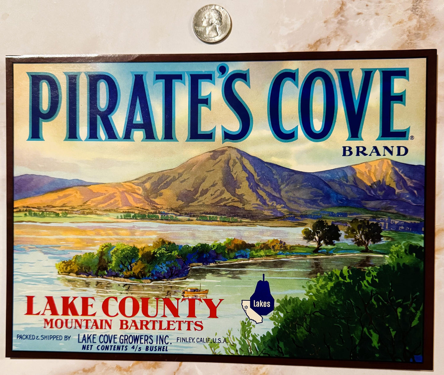 Vintage fruit crate label for Pirate's Cove Brand mountain bartletts from Lake County, featuring a landscape with mountains a