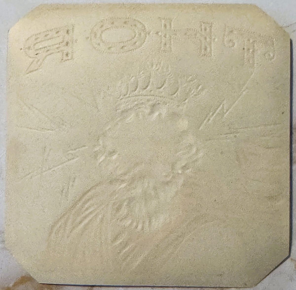 Cream-colored embossed stone or plaster tile featuring Thor's bearded face and upper body in relief, with decorative text at 