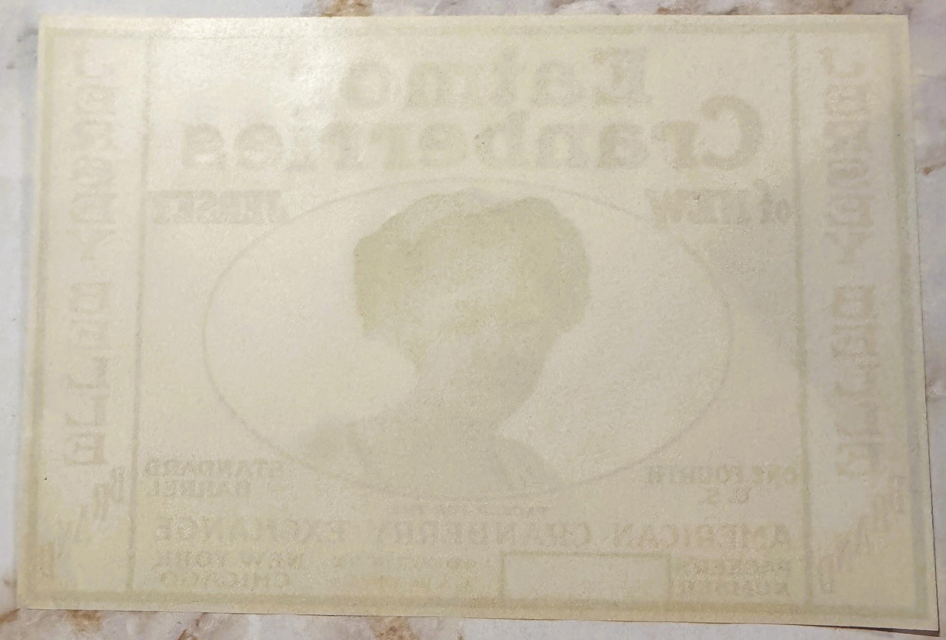Cream-colored vintage cranberry barrel label with faded embossed design showing a profile portrait in center, text visible ar
