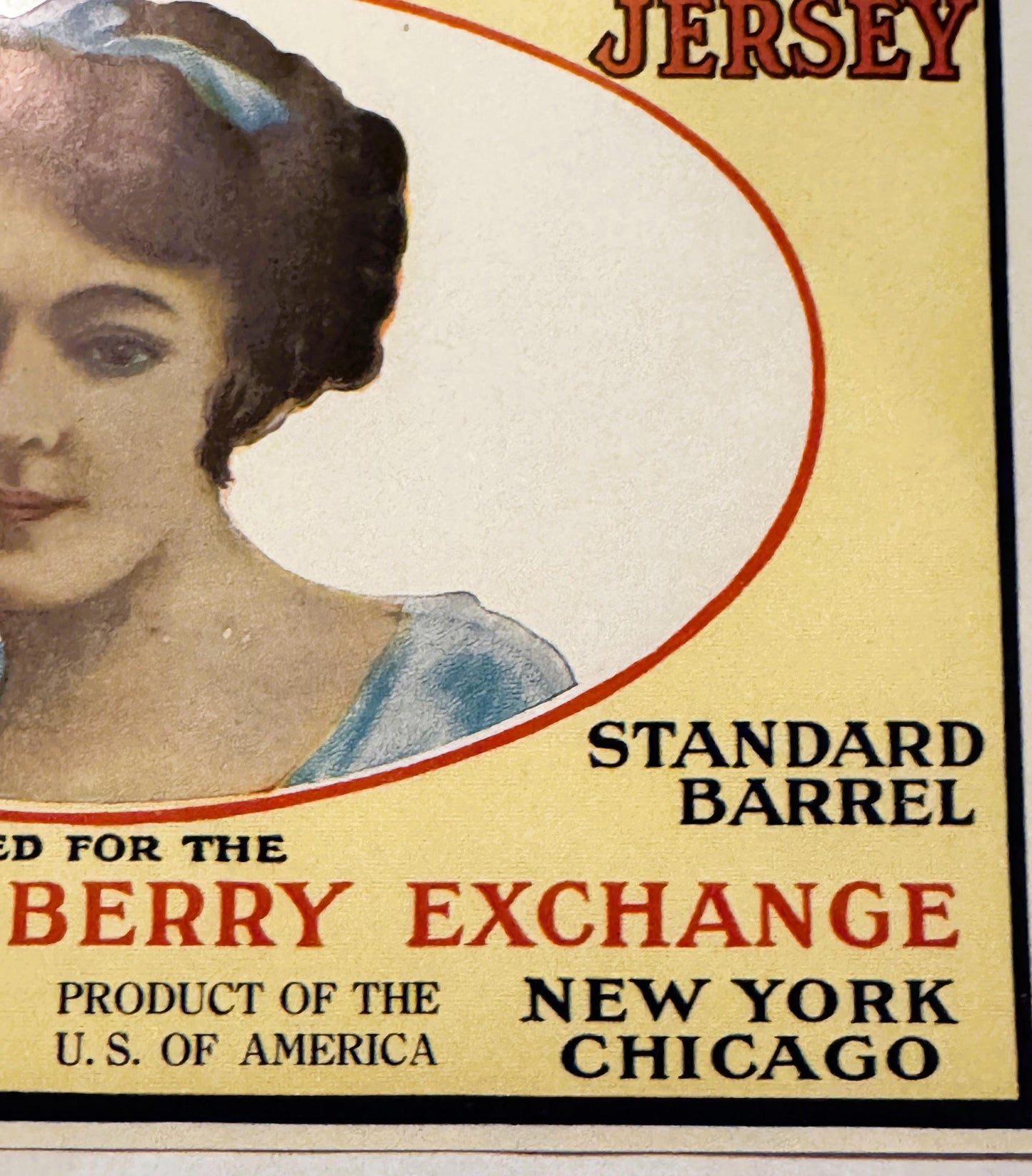 Vintage cranberry barrel label featuring a woman's profile in an oval frame, yellow background, red text reading "Jersey Bell