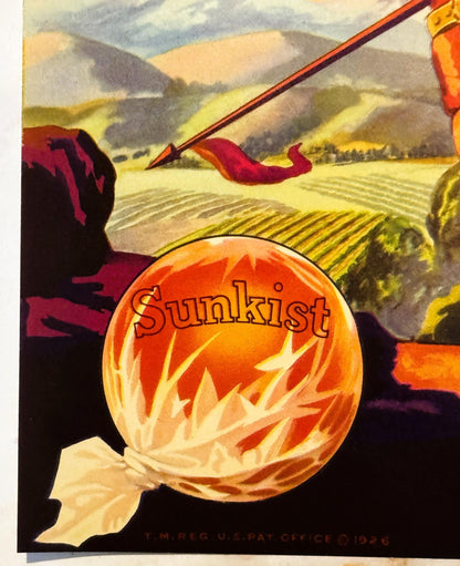 Vintage citrus crate label featuring a large orange with "Sunkist" text, red ribbons, and a valley landscape background with 