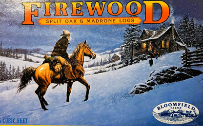 Vintage firewood crate label featuring a cowboy on horseback in snowy landscape with cabin, mountains and evergreens under st