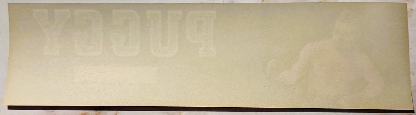 Cream-colored vintage crate label with faint "PUGGY" text visible at top and dark stripe along bottom edge, unfilled stock im