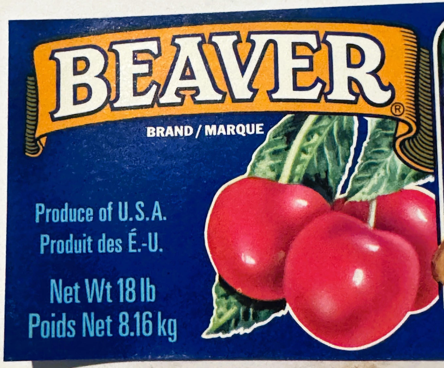 Vintage Beaver Brand cherries crate label with bilingual text, red cherries with green leaves on blue and yellow background, 