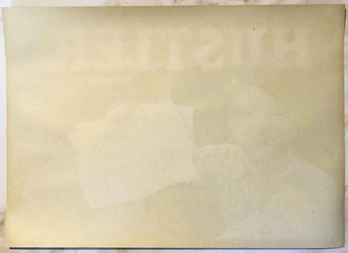 Blank cream-colored vintage crate label with faint watermark impressions, yellowed with age spots and creasing