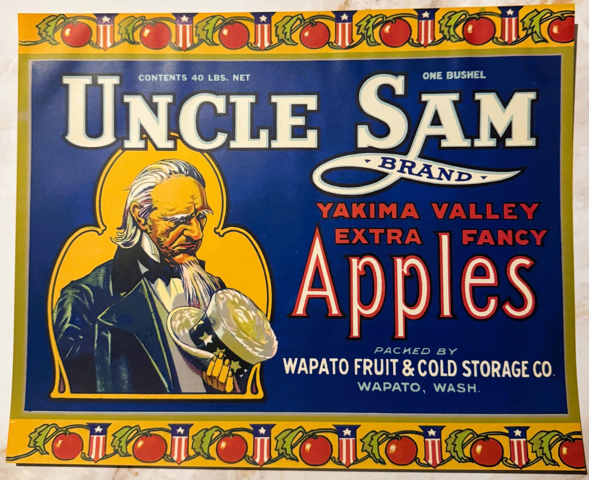 Vintage Uncle Sam Brand apple crate label with bearded Uncle Sam holding an apple, red and blue design with yellow border and