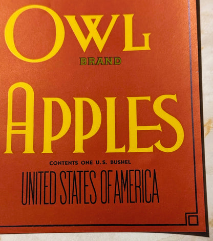 Antique Owl Brand Apples crate label with yellow text on red-orange background, listing one U.S. bushel contents and United S