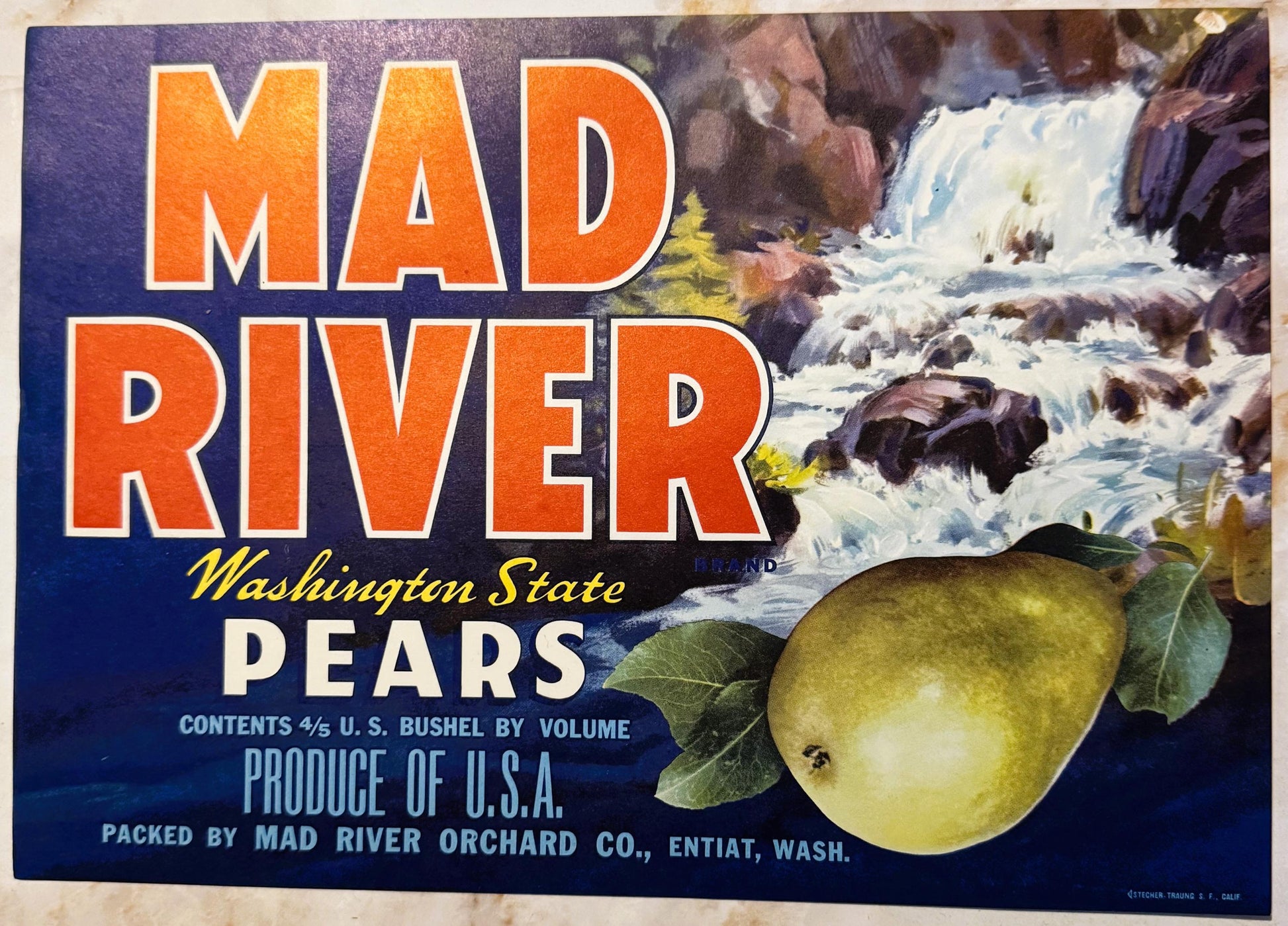 Vintage Mad River pears crate label with orange text on blue background, featuring waterfall scene and two green pears with l