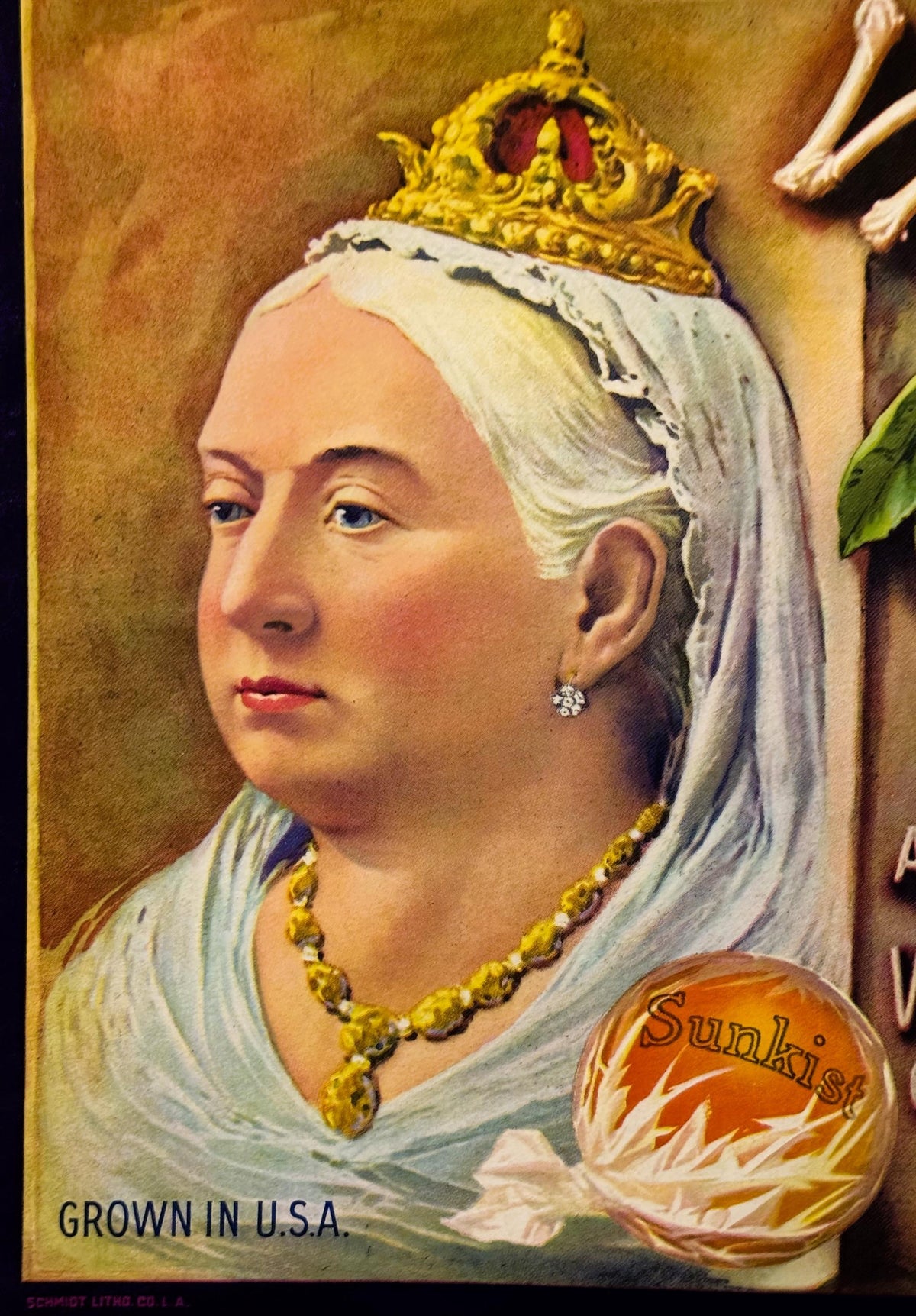 Vintage fruit crate label featuring a woman in white headdress and gold crown, wearing gold necklace, with "Sunkist" orange a