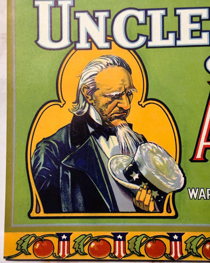 Vintage fruit crate label featuring Uncle Sam in formal attire holding a large apple, with tomatoes and patriotic shields alo