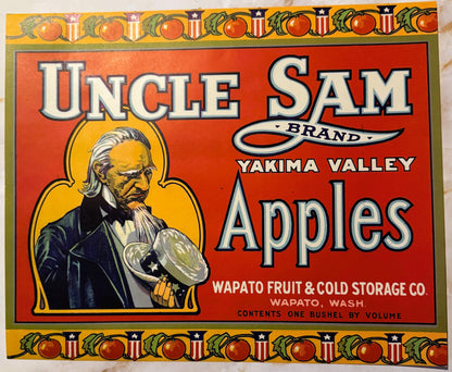 Vintage red fruit crate label featuring Uncle Sam in yellow halo holding an apple, "Yakima Valley Apples" text, Wapato Fruit 