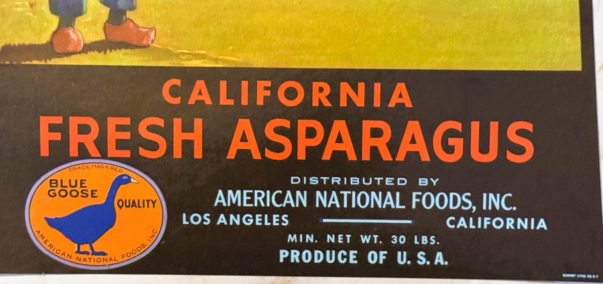 Vintage asparagus crate label with orange text on dark background, Blue Goose quality mark, distributed by American National 