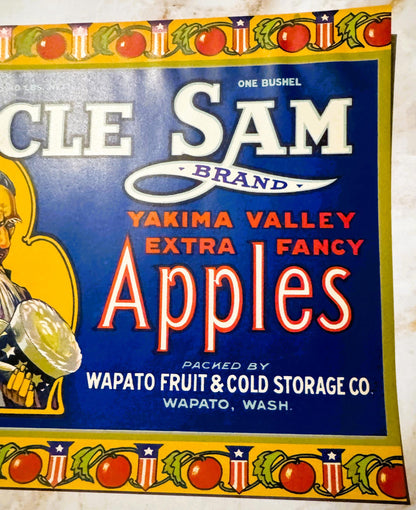 Vintage fruit crate label with blue background featuring "Uncle Sam Brand" text, red tomatoes at top border, and "Yakima Vall