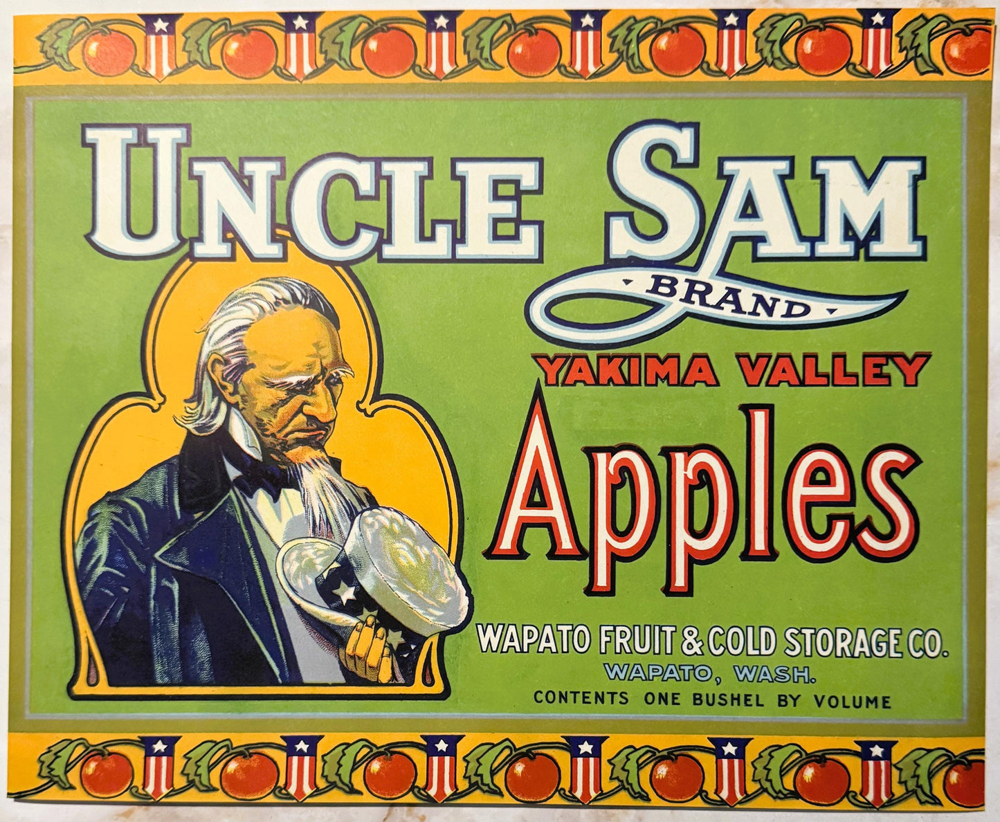 Vintage Uncle Sam Brand Yakima Valley Apples crate label with patriotic border, bearded Uncle Sam figure holding an apple, gr